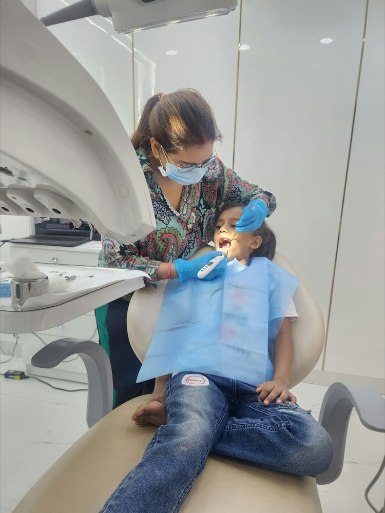 Dentist examining a child in the dental chair